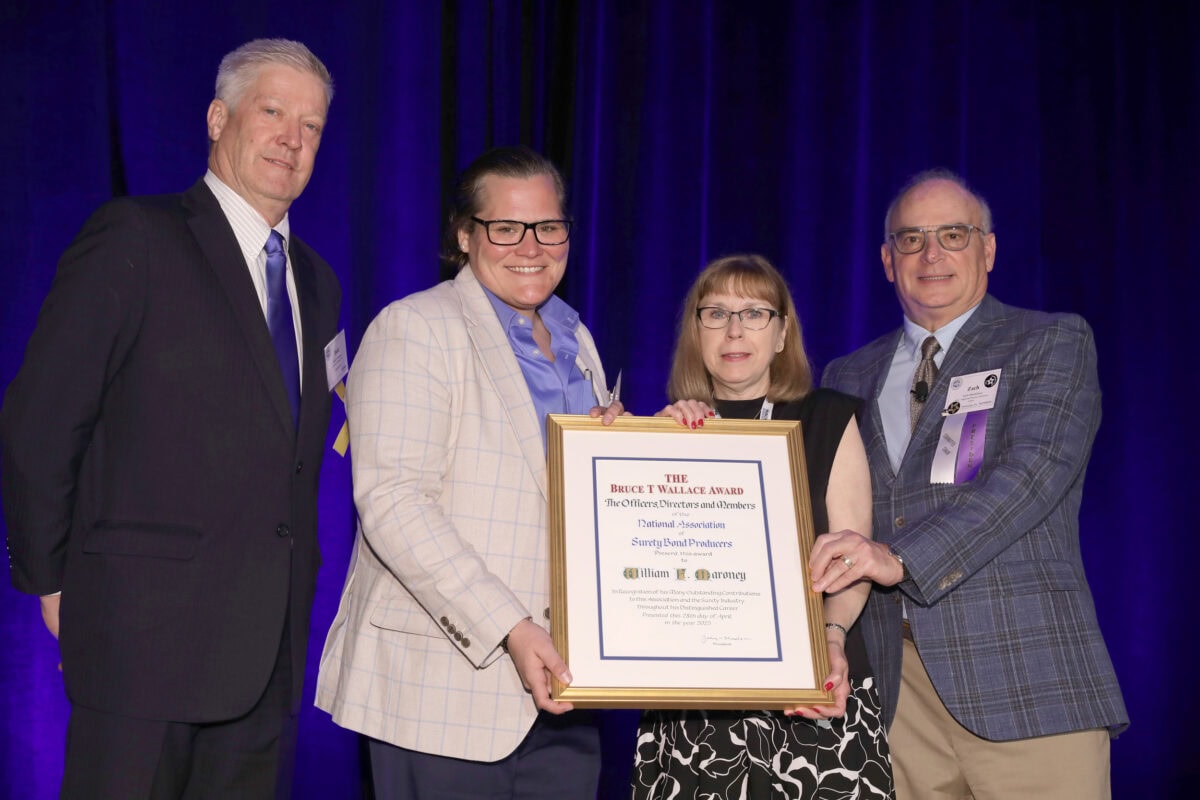 Todd Loehnert, Florence Maroney, Florence Maroney, and Zach Mendelson post with Bruce T. Wallace Award.