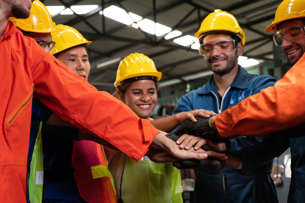 skillful worker stand together showing teamwork in the factory .