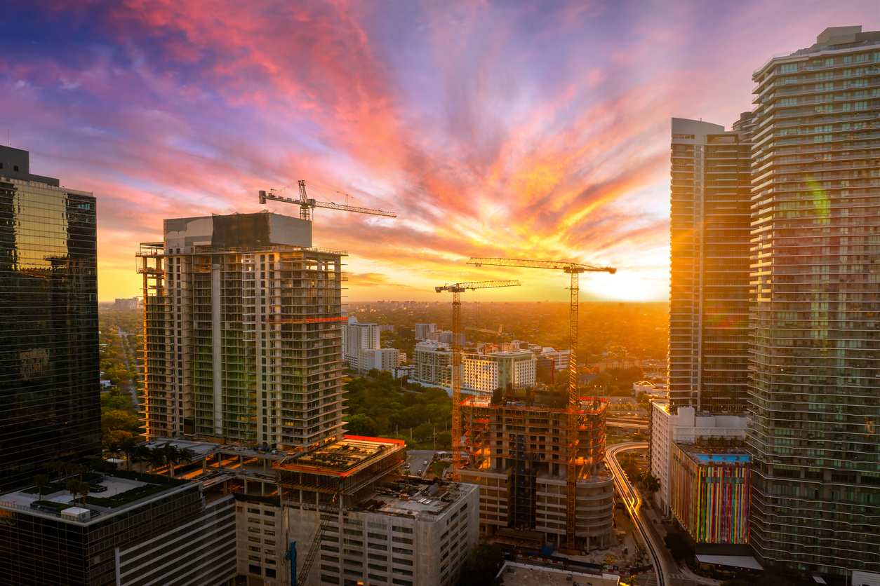 miami, florida. developing american megapolis with new high rise buildings under construction at sunset