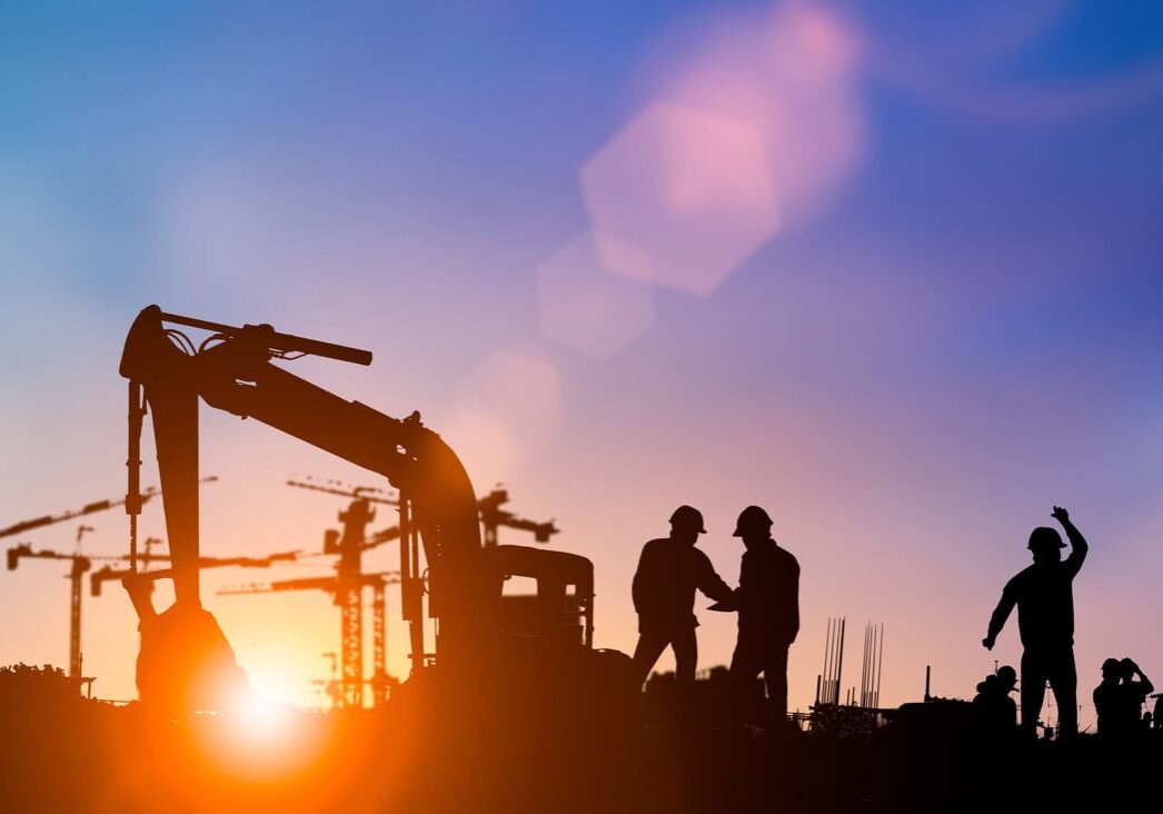 Silhouette of engineer and construction team working at site over blurred background for industry background with Light fair.Create from multiple reference images together