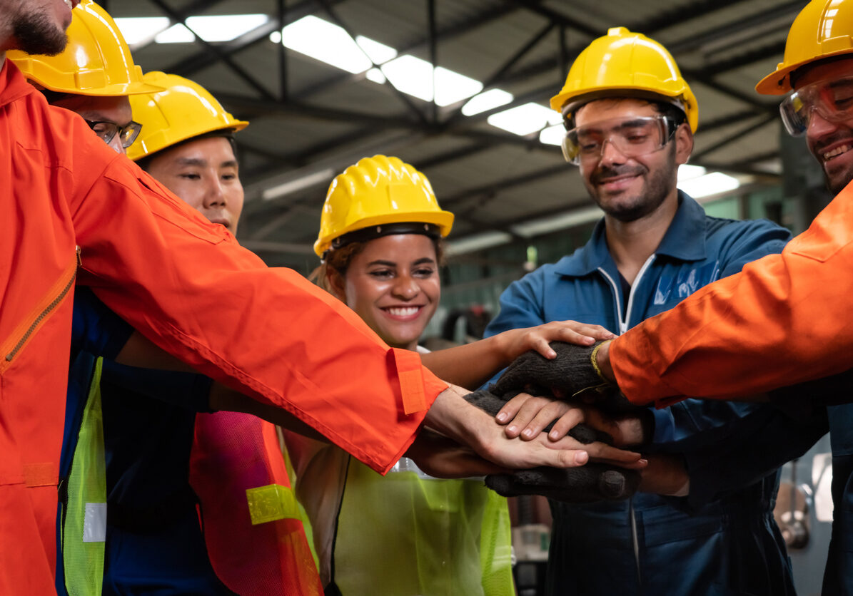 skillful worker stand together showing teamwork in the factory .